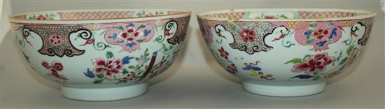 A pair of Chinese famille rose bowls, Qianlong period, 23.3cm, some faults, wood stands